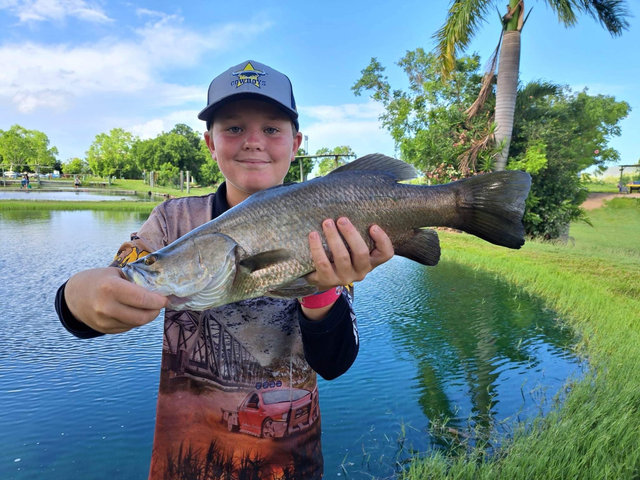 a boy holding a fish in the water